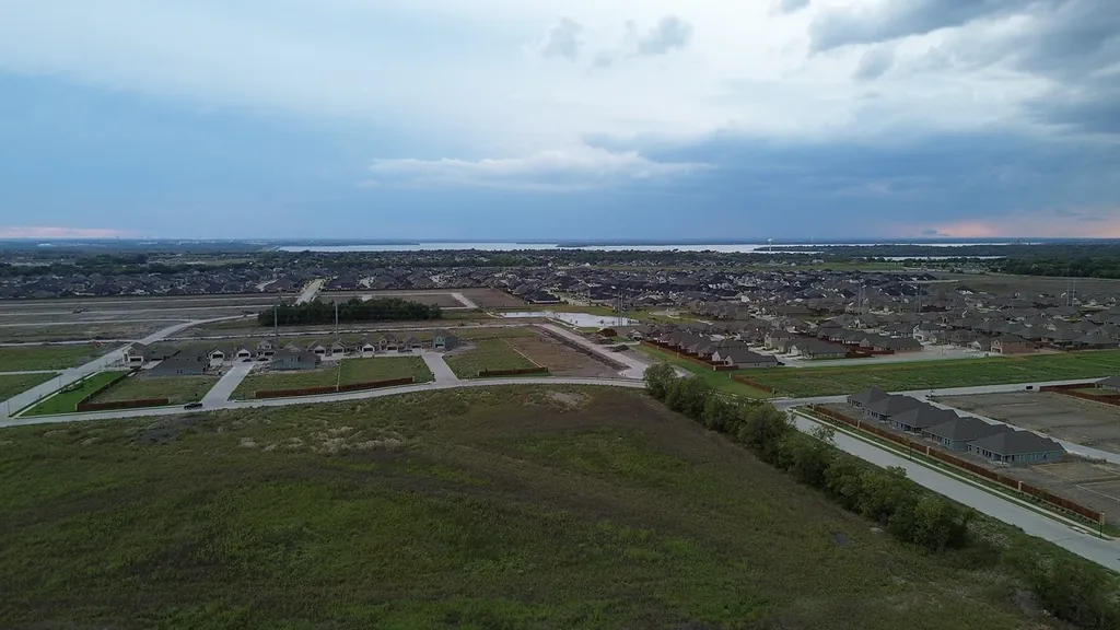 Aerial view of a new residential development with paved streets and graded lots