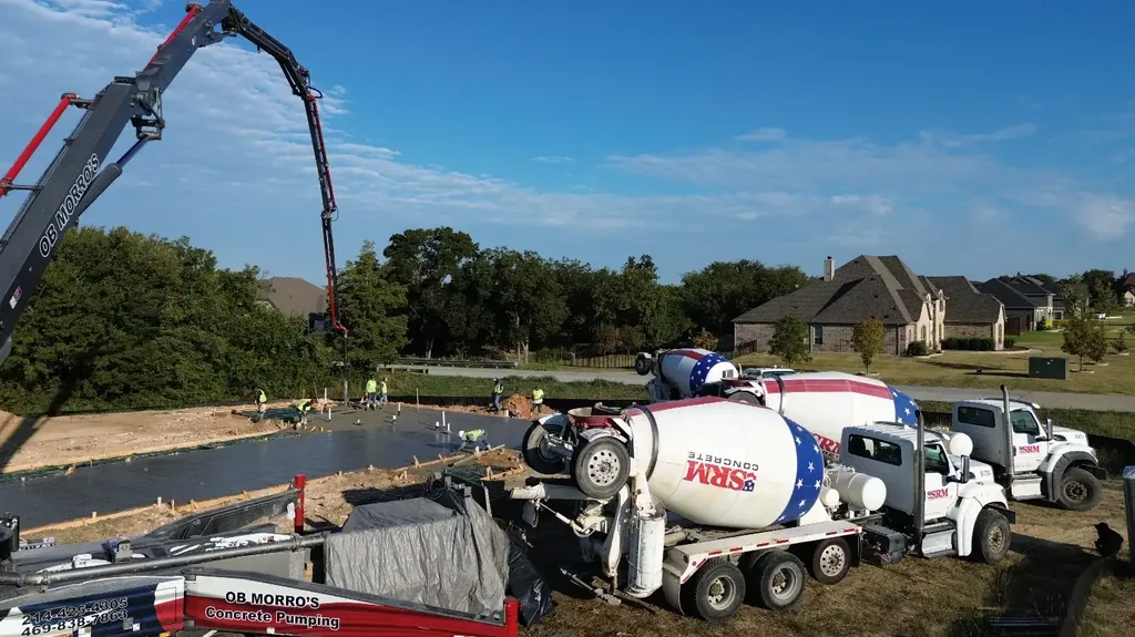 Pump and ready-mix trucks at a foundation pour