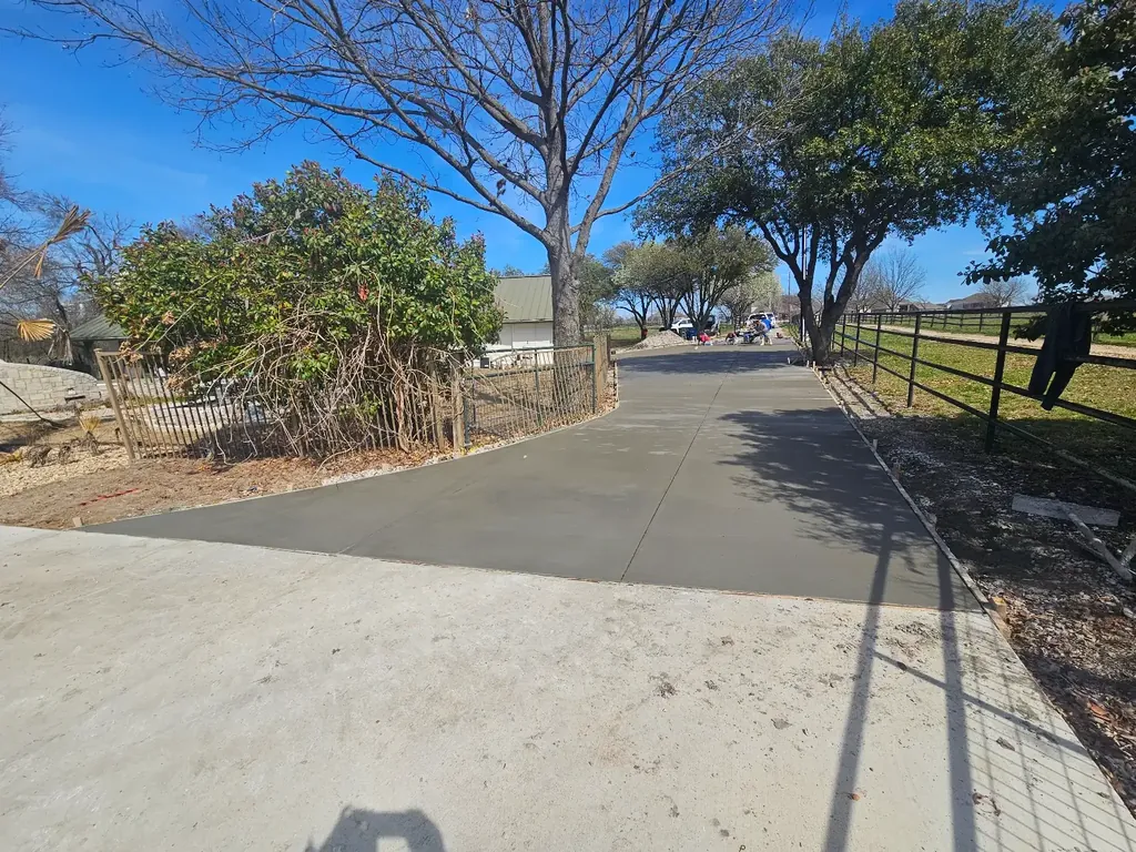 Concrete driveway extension along an existing drive