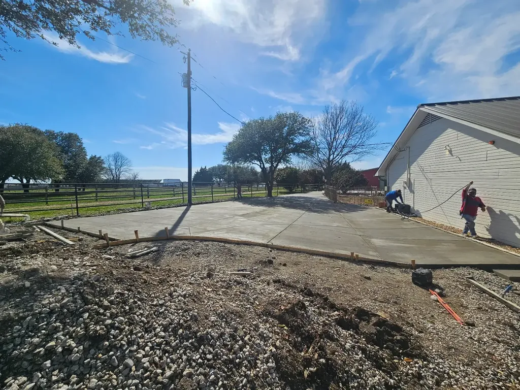 Fresh concrete pad beside a home