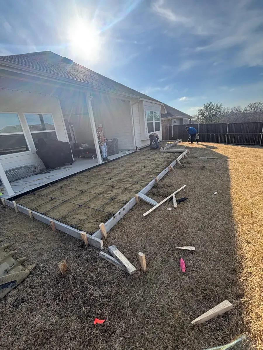 Patio forms and rebar behind a home
