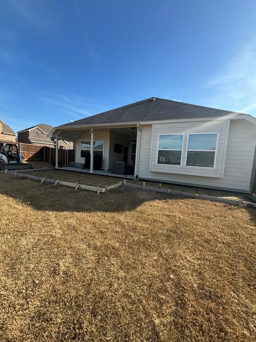 Patio forms and rebar behind a home