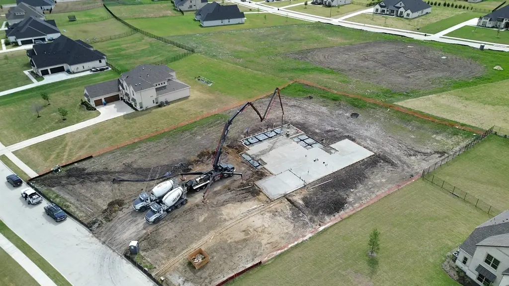 Foundation pour with pump and ready-mix trucks (aerial)