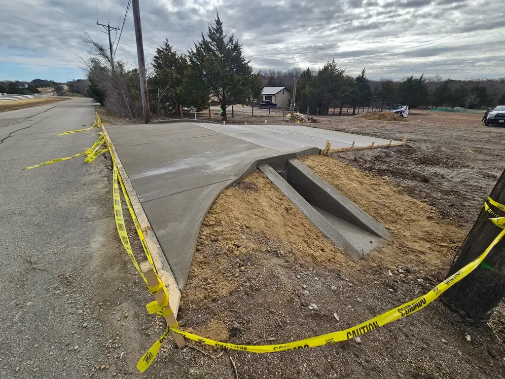 Driveway approach with culvert headwall (fresh work)