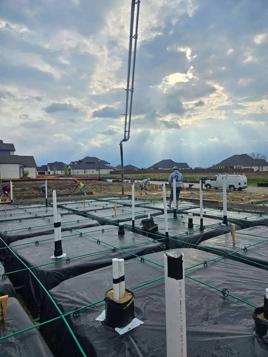 Post-tension foundation prepared for a pour, with tendons, plumbing sleeves and vapor barrier in place